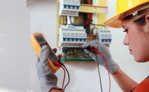 Frau prüft Stromkasten